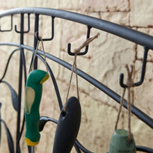 Load image into Gallery viewer, Black Metal Potting Bench with Wrought Iron Vine Details and Fabric Potting Sink